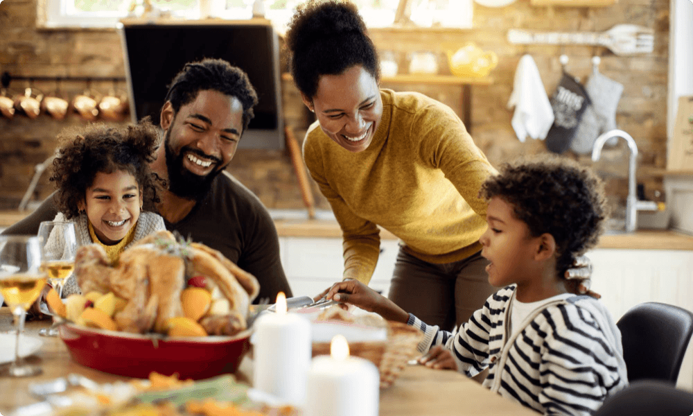 happy family having fun during thanksgiving dining table