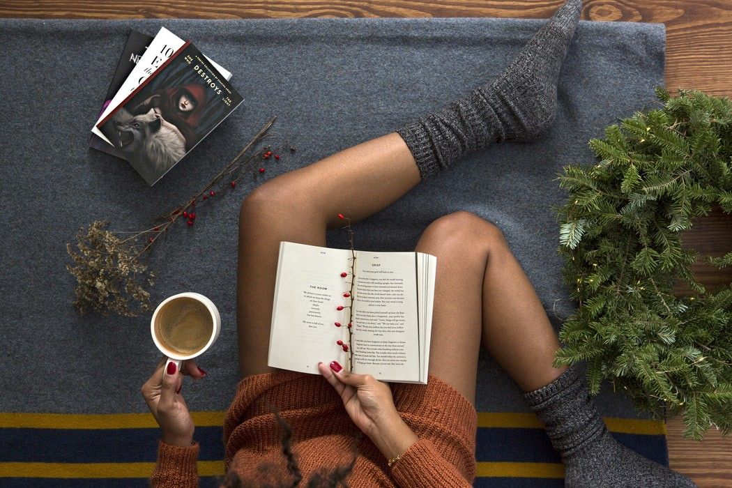 lady sitting on the floor reading a book