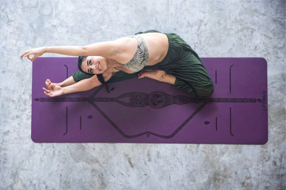 Beautiful woman on a liforme mother earth yoga mat to test out promotion gift ideas