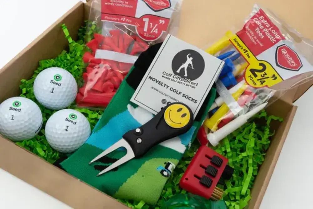 Golf gift box including golf balls, tools and socks.