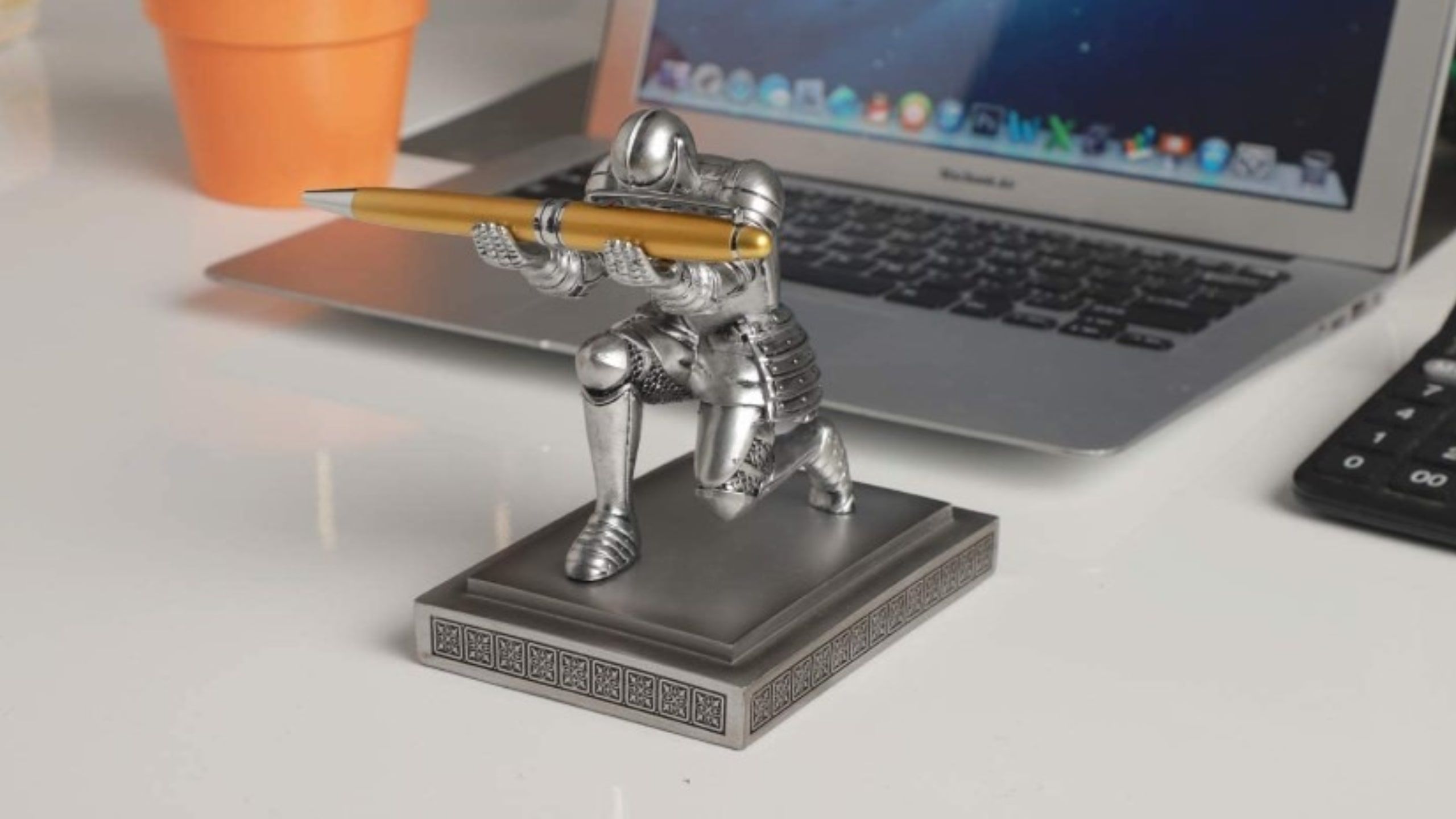 iron knight that holds a pen 