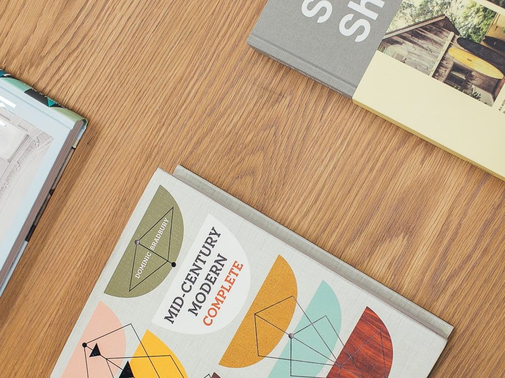 art books in display on wooden table