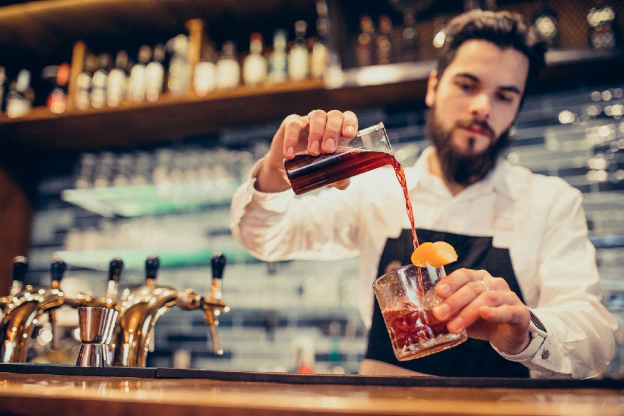 bartender making cocktails at the counter