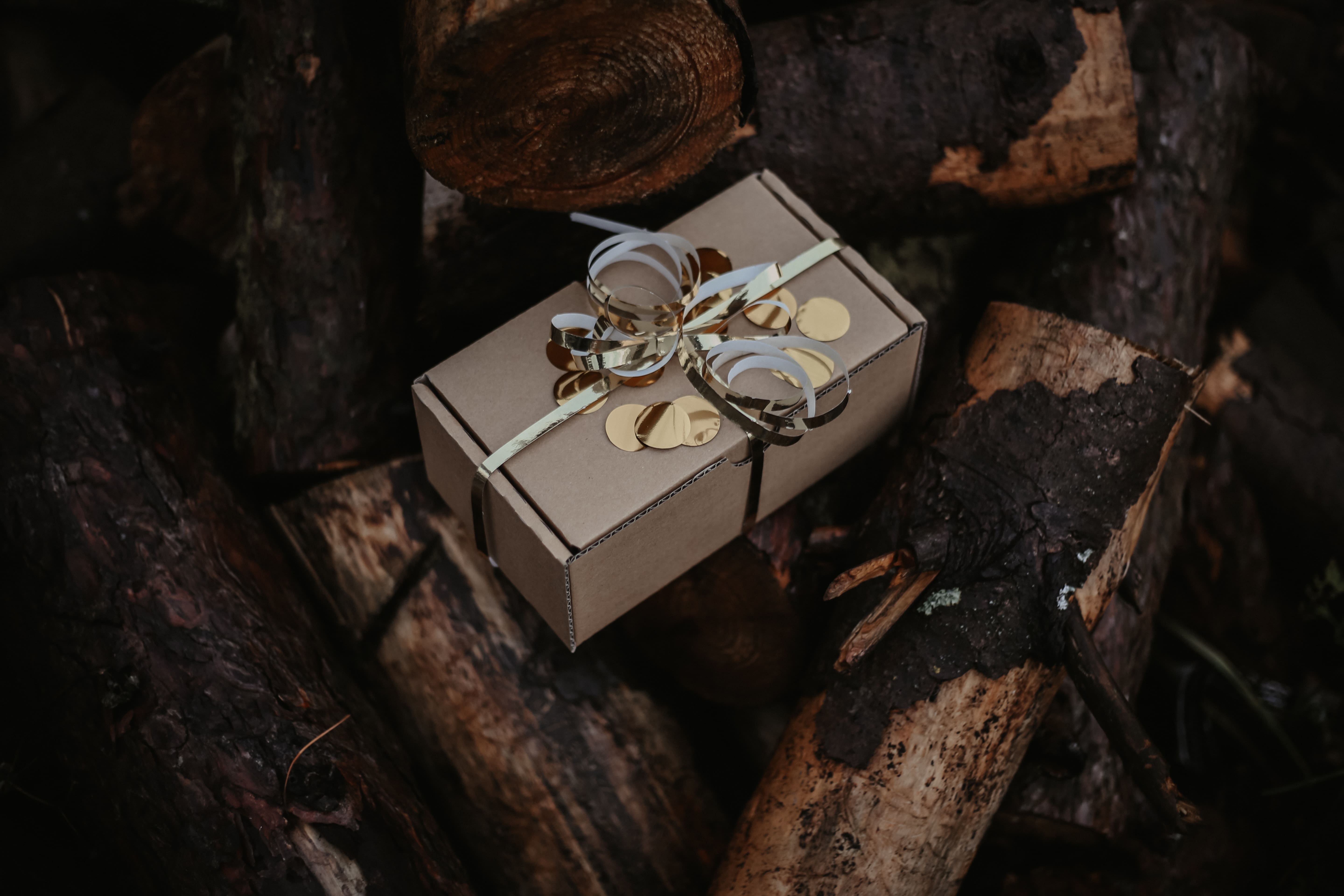 an exclusive gift box on top of a stack of woods