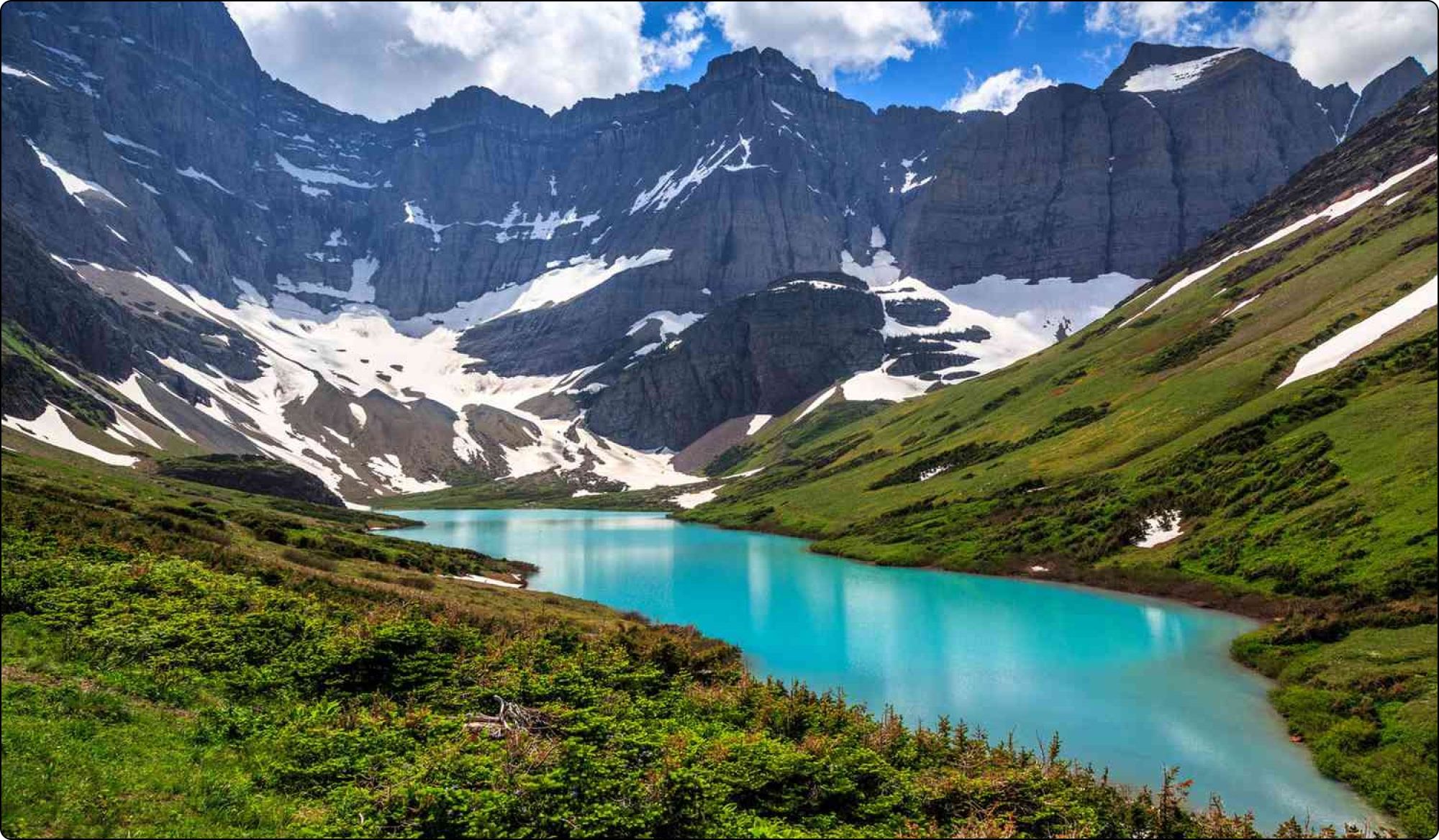 beautiful lake under snowy mountain and a national park