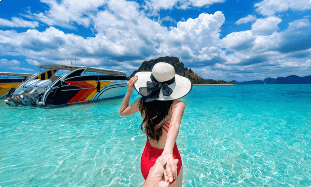 bikini girl holding with man leading him to the ocean as one of her promotion gift ideas