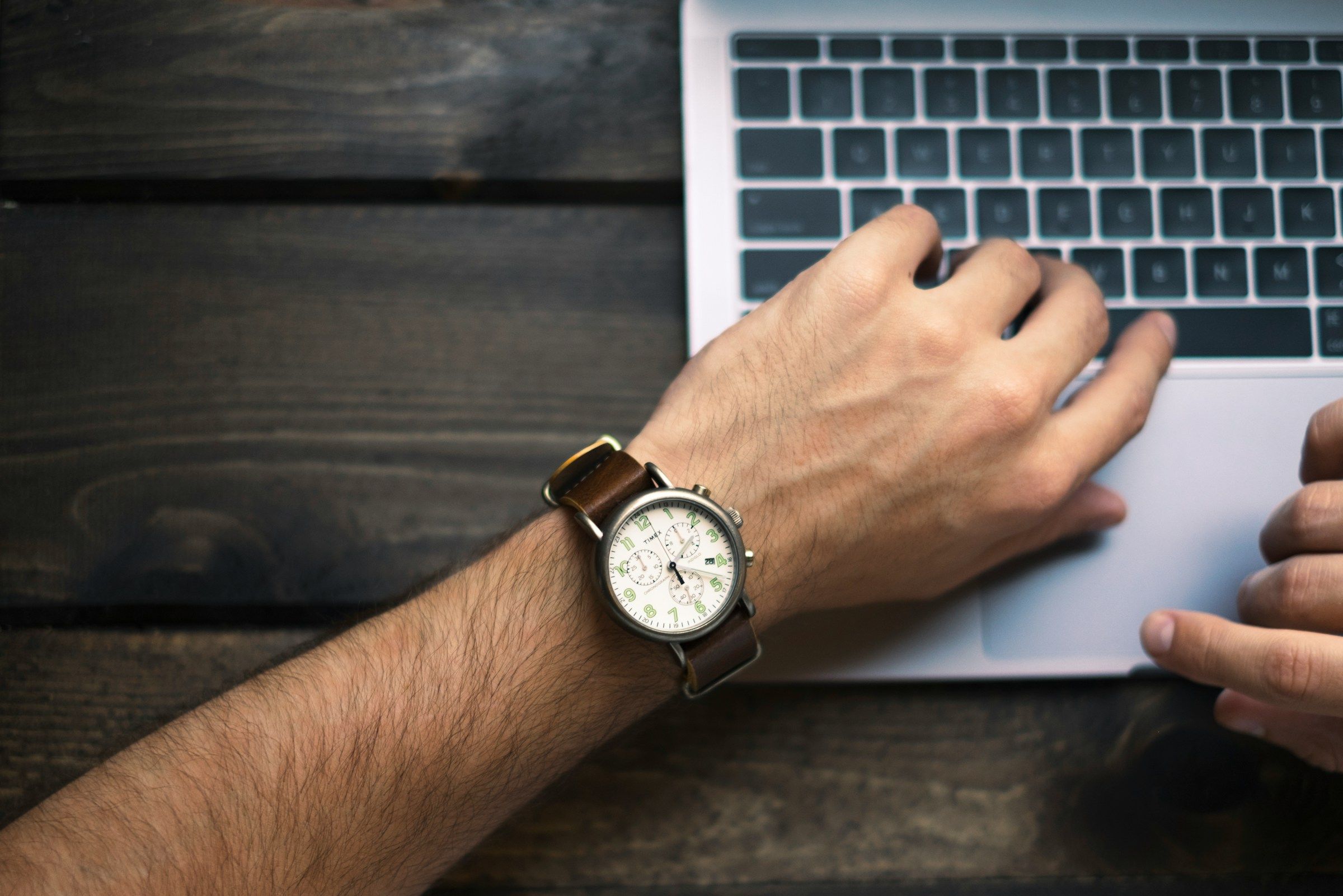 man looking at his watch - Effective Onboarding