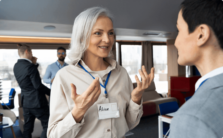 business woman talking to another person at an event
