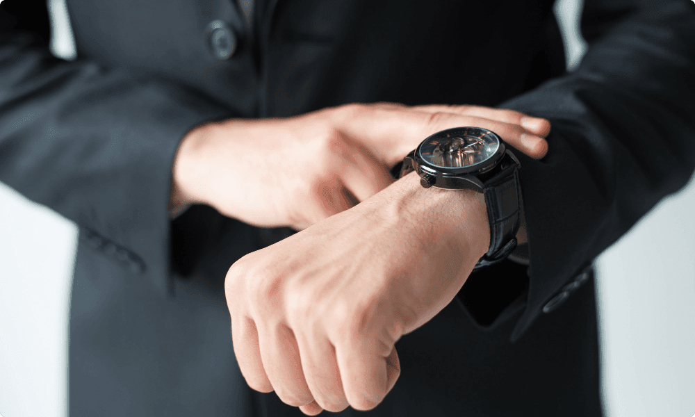 businessman consulting wristwatch as timing is important