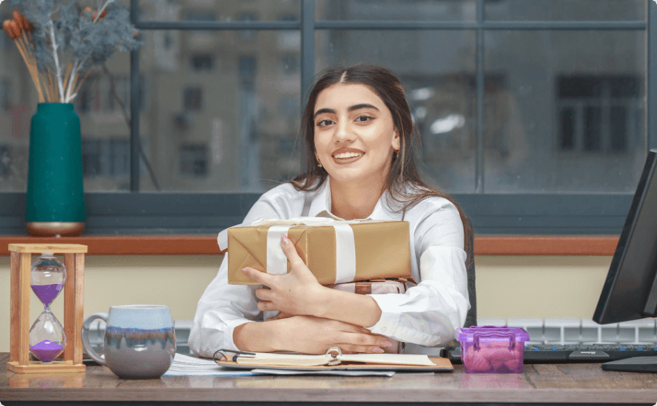 business women holding expensive employee appreciation gifts