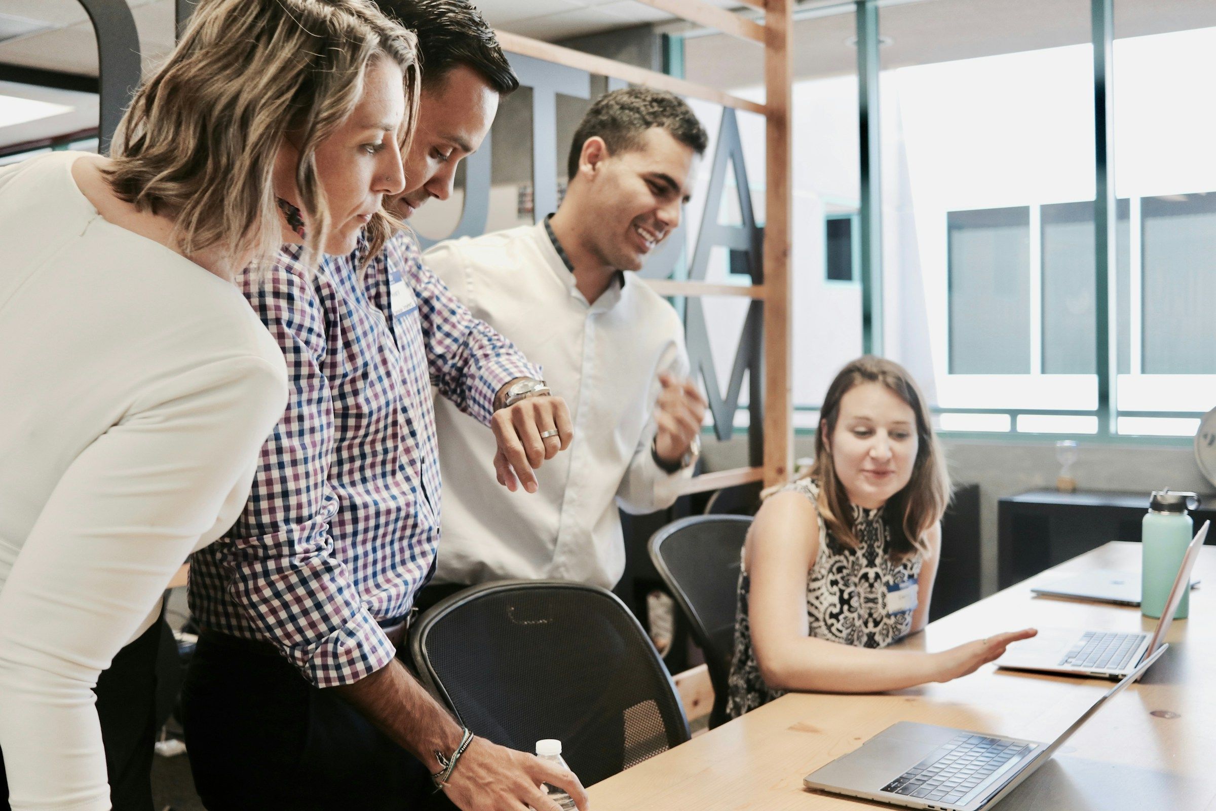 team infront of laptop - Holiday Staff Appreciation Ideas