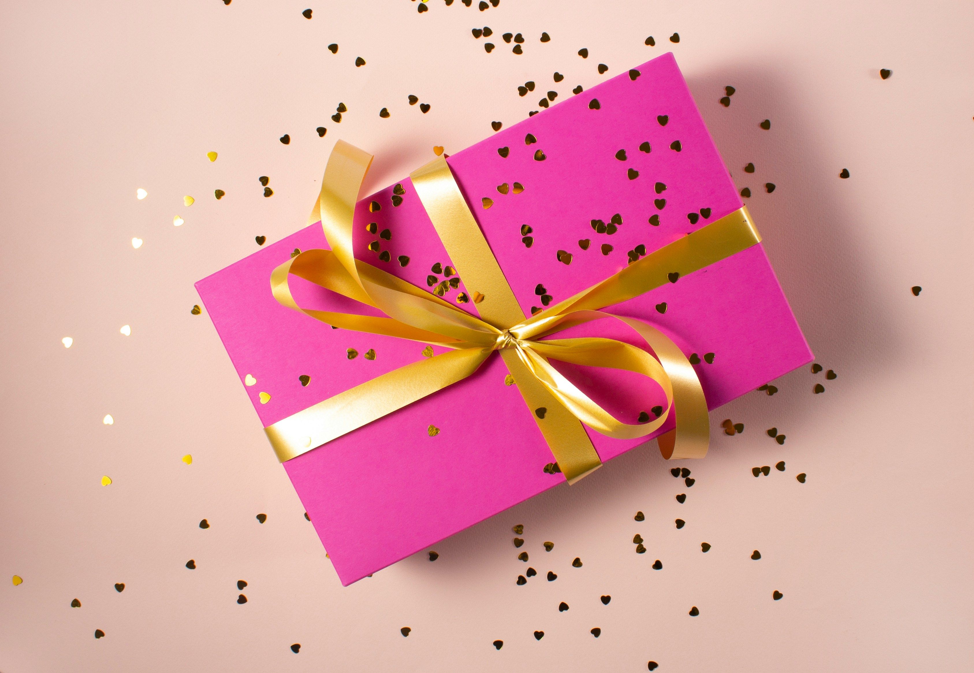 pink wrapped gift - Corporate Holiday Gift Guide