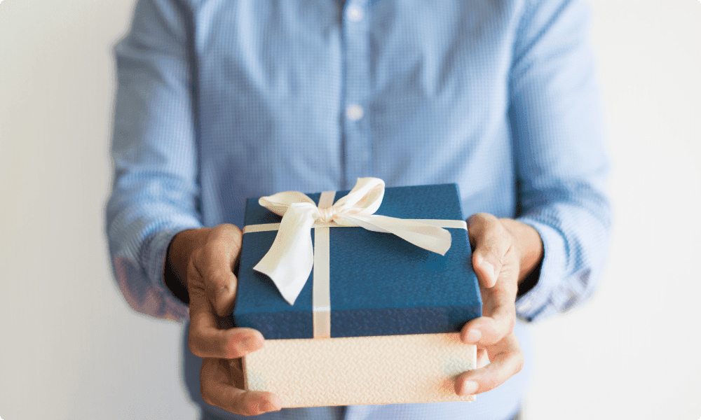 An employee receiving small client gifts from his boss for employee appreciation