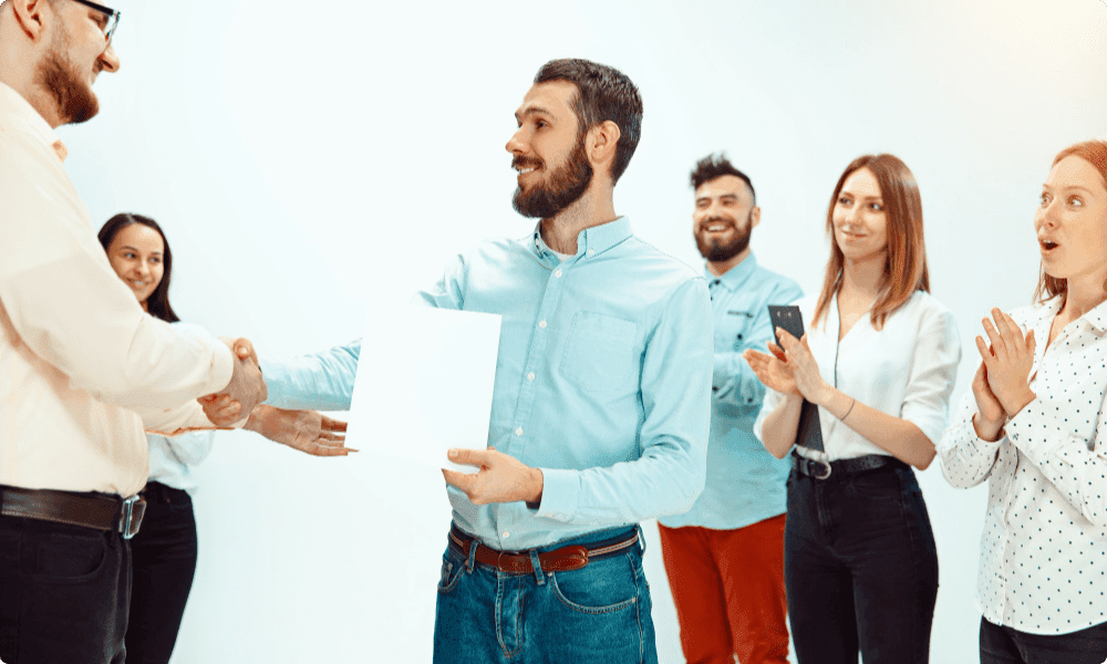 boss giving letter and employee recognition gifts for years of service