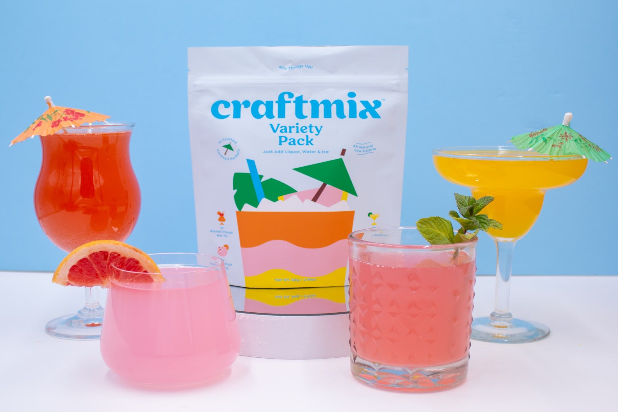 four different types of cocktail mixers with the package in the middle