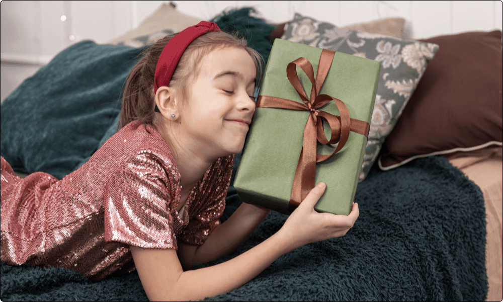 funny little girl with christmas gift box