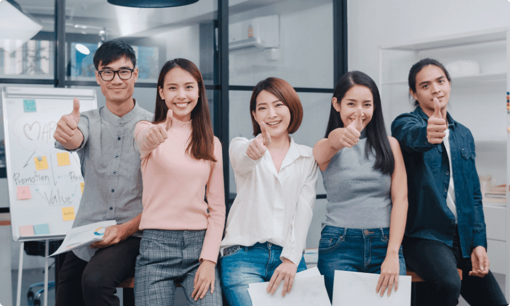 group of young creative and smart employees with casual wear smiling thumbs up