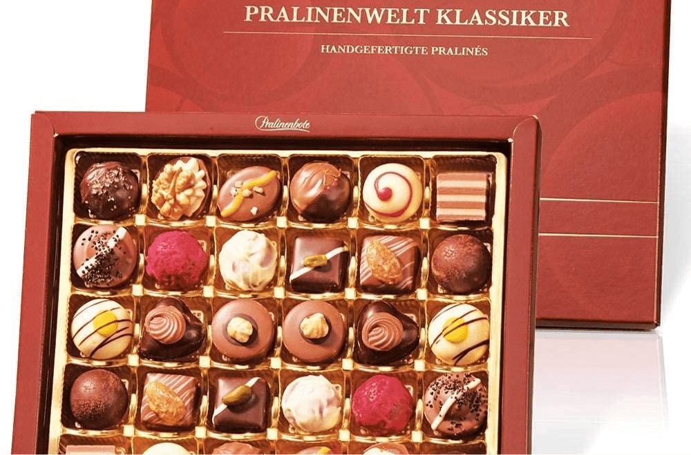red chocolate box with premium chocolate to be gifted as client appreciation gifts with a coffee kit