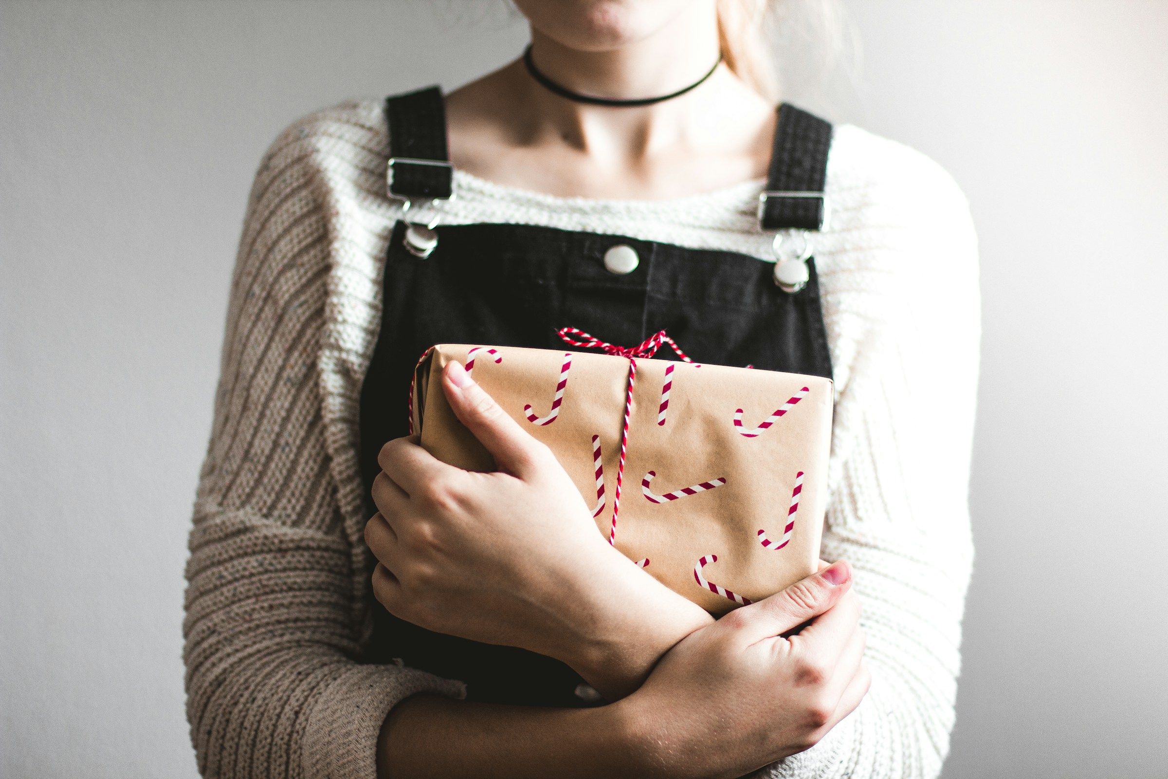 woman happy with her gift - What To Get Employees For Christmas