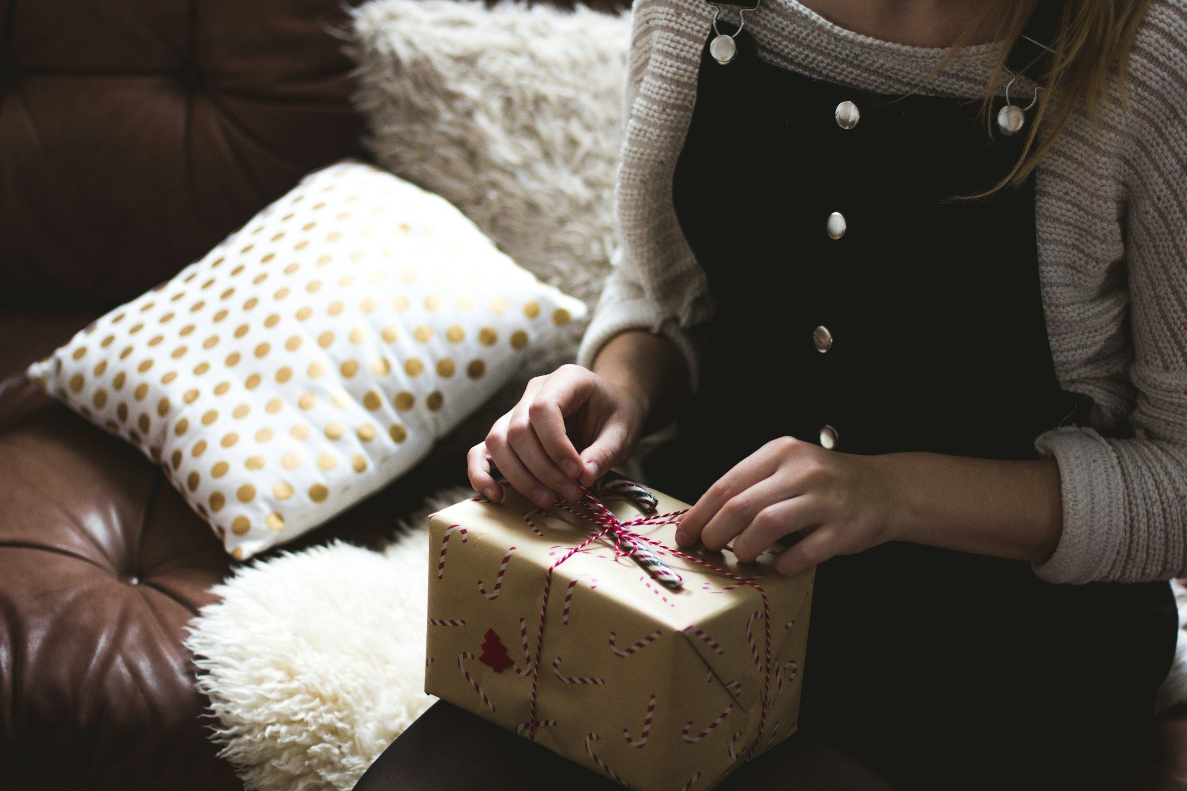 person opening up a gift - Inexpensive Customer Appreciation Gifts