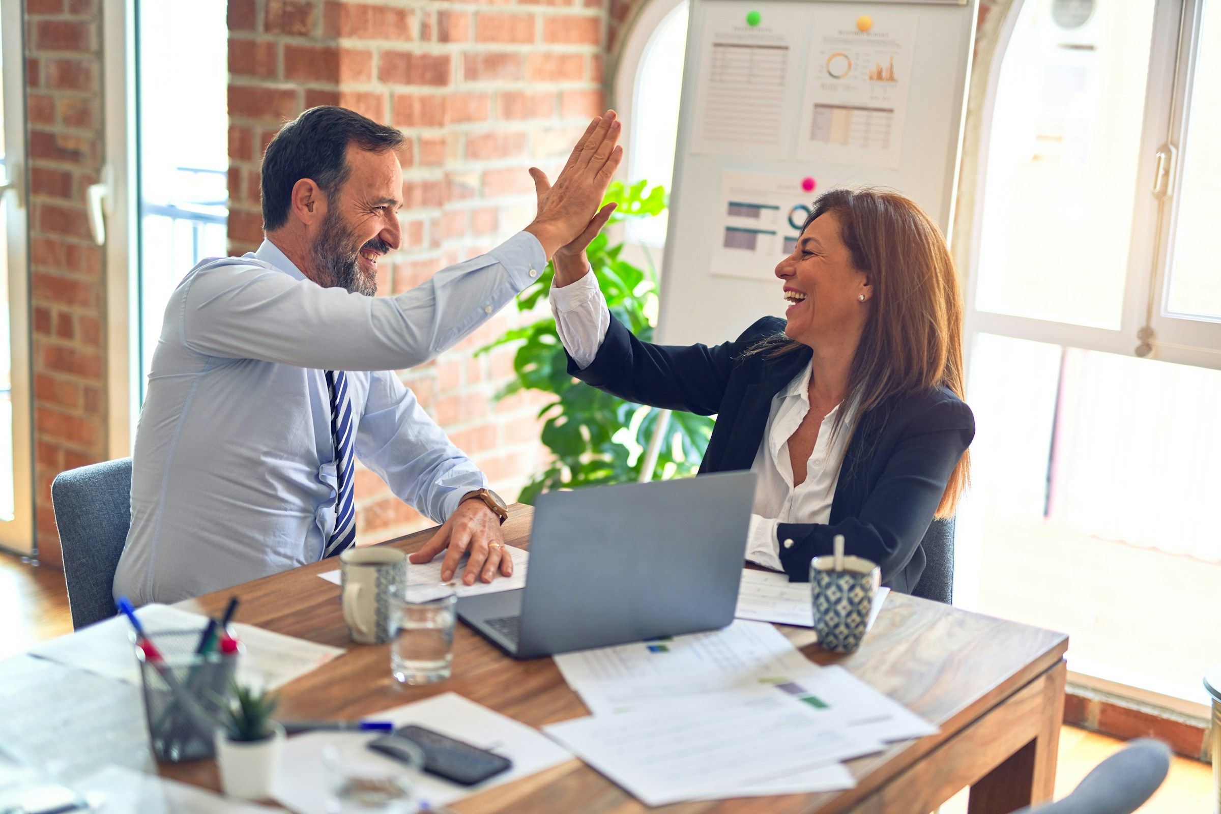 woman giving a high five - Holiday Staff Appreciation Ideas