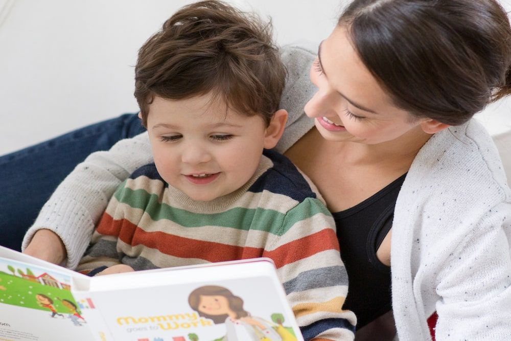 mother reading storybook to her child