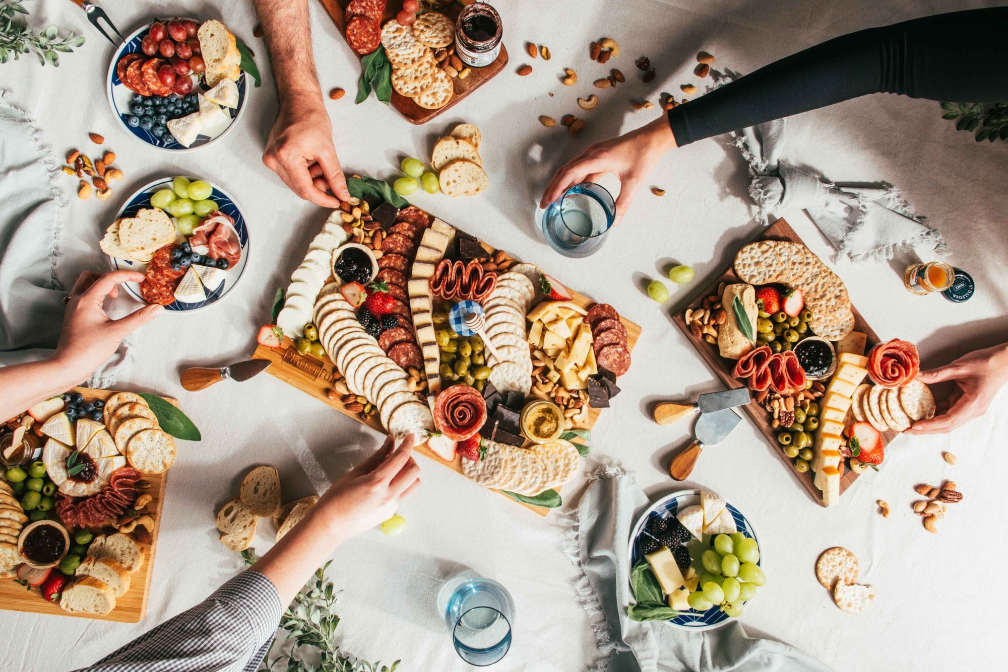 people sharing charcuterie board at a gathering