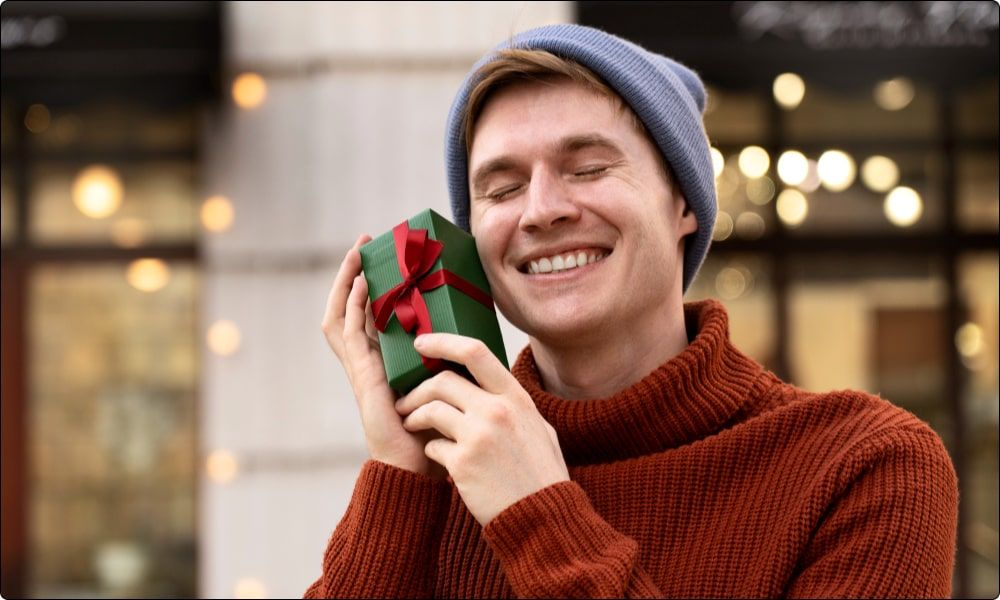 smiling man loving the christmas gifts he received
