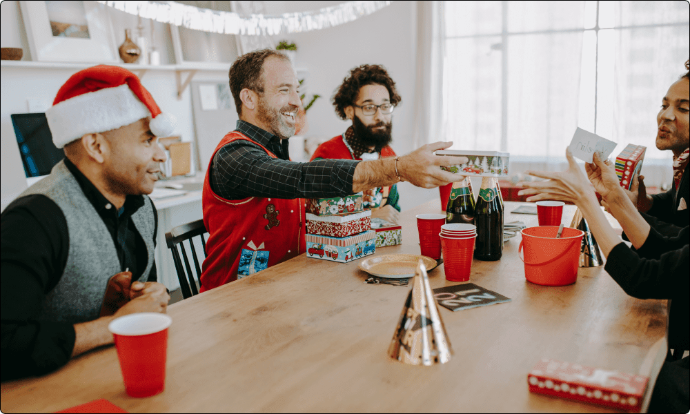 team members handing out secret santa gifts to each other