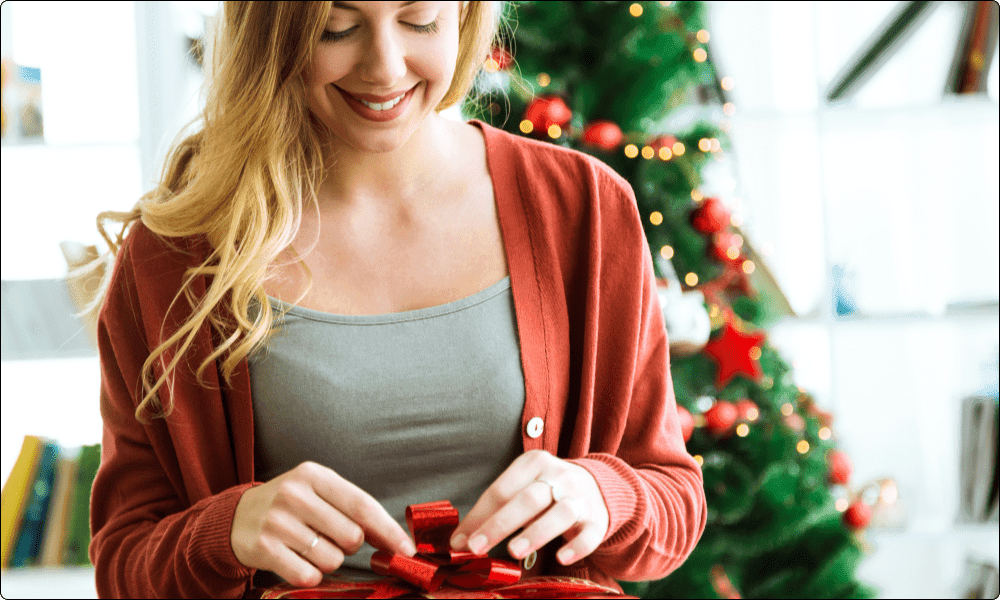 woman feeling happy opening a gift