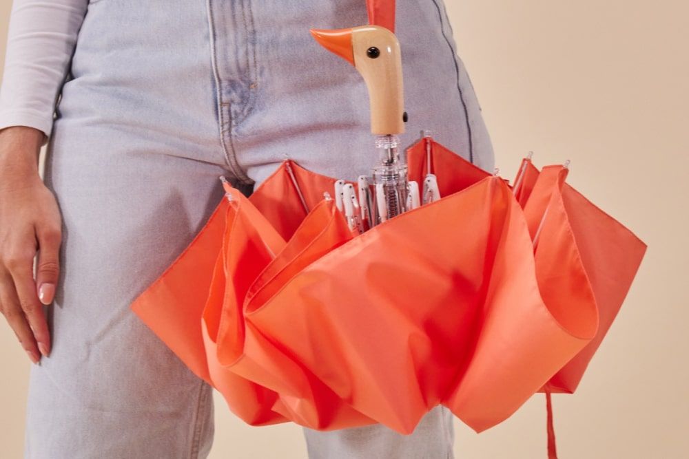 woman holding original duckhead peach windproof umbrella