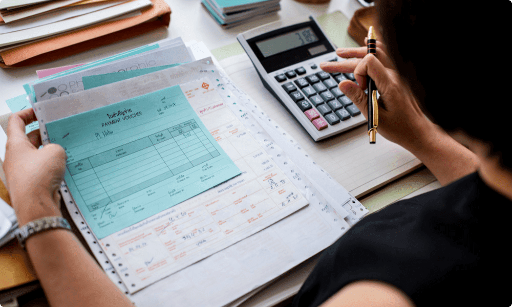 woman working on tax paperwork after successful employee recognition program