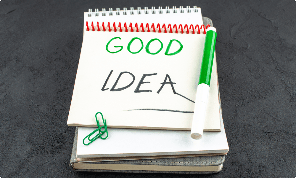 written spiral notebook with the words good idea - employee recognition ideas