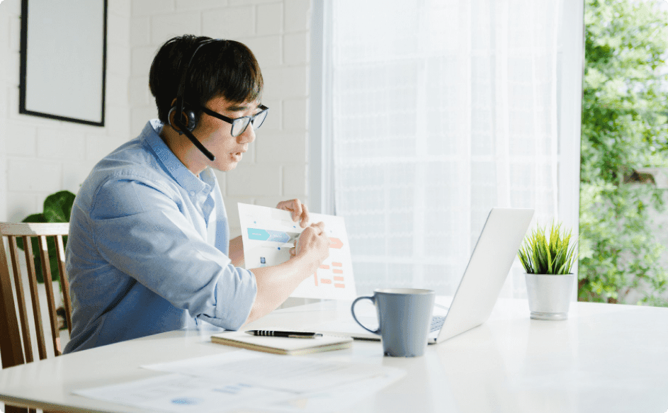 young businessman using laptop to teach about creative employee recognition ideas